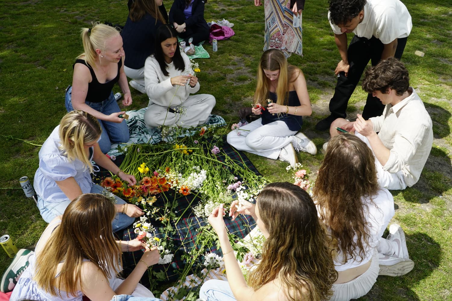 Group assembling flower crowns on the ground
