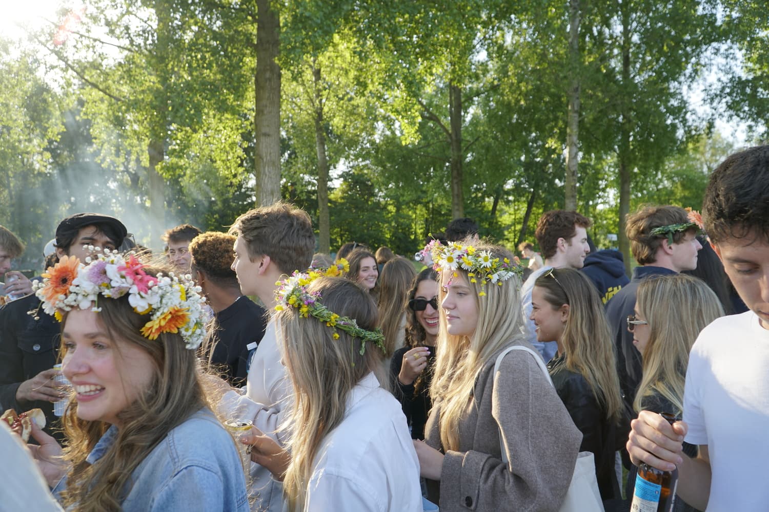 Crowd gathered in a park during Midsummer celebration